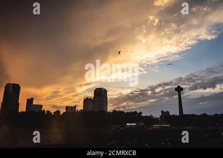 Sunset over Niagara Falls with Canadian skyline in the background Stock Photo