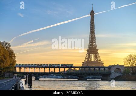 Paris France city skyline sunrise at Eiffel Tower and Seine River with Pont de Bir-Hakeim bridge and