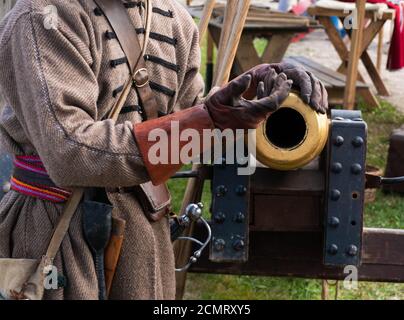 Ancient gun and hands in leather gloves Stock Photo