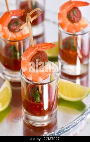 Appetizer of shish kebab with shrimps and chorizo sausages with barbecue sauce in a glass Stock Photo