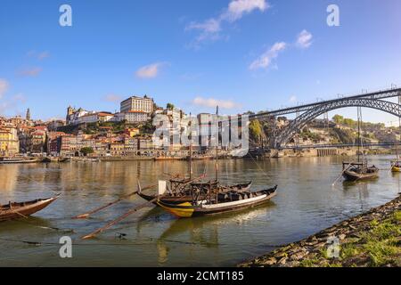 Porto Portugal city skyline at Porto Ribeira and Douro River with Rabelo wine boat and Dom Luis I Br Stock Photo