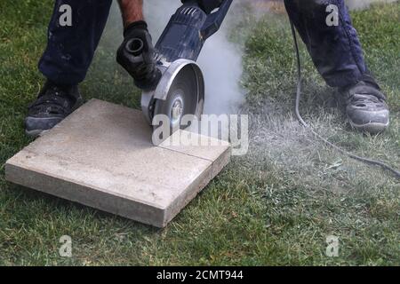 Construction worker using a professional angle grinder Stock Photo