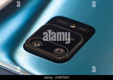 Blue modern phone quad camera lens and flash close-up. Selective focus Stock Photo