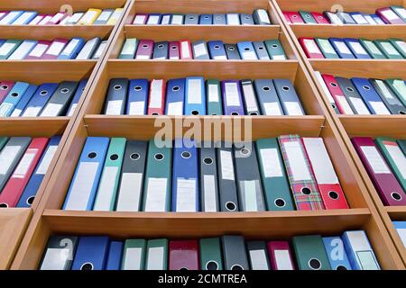 file folders, standing on the shelves in the background Stock Photo