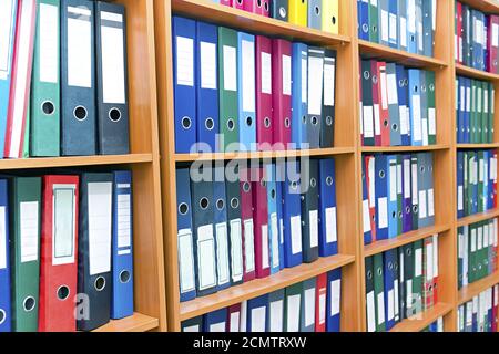 file folders, standing on the shelves in the background Stock Photo