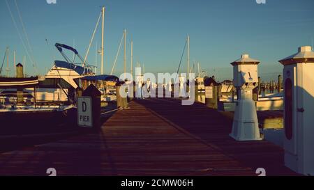 Small Harbor during early morning light looking down pier Stock Photo