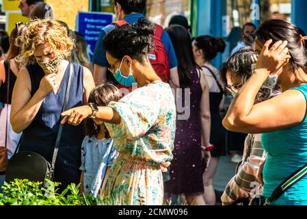 London, United Kingdom - September 13, 2020: Columbia Road Flower Sunday market.  People in masks are buying flowers Stock Photo
