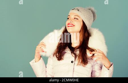 Warm and cozy. Girl wear winter jacket blue background. Winter