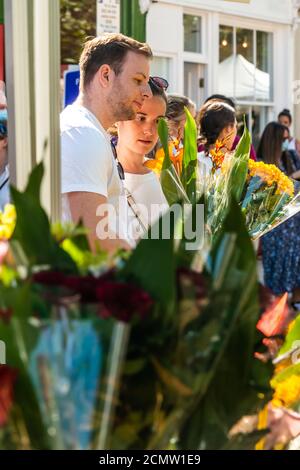 Couple choosing flowers at market Stock Photo - Alamy