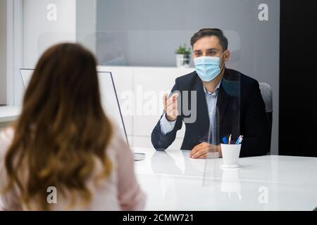 Young Woman Meeting Consultant Or Lawyer With Face Masks Stock Photo