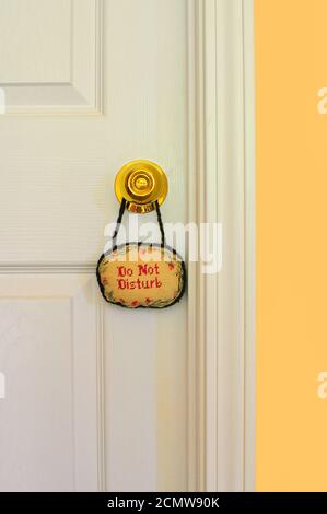 Do Not Disturb Sign hanging on a door Stock Photo