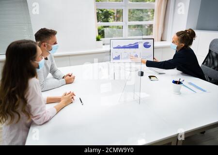 Young Family Couple Meeting Financial Advisor With Face Masks Stock Photo