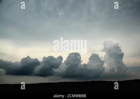 Pillars of storm clouds building up in a gloomy sky Stock Photo