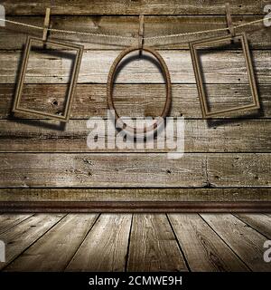 three picture frame hanging on clothespins on a background of of wooden wall Stock Photo