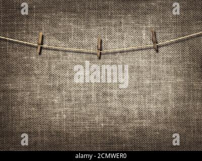 clothesline with clothespins on linen background Stock Photo