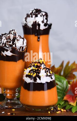 Pumpkin chocolate beverage with whipped cream and chocolate topping Stock Photo