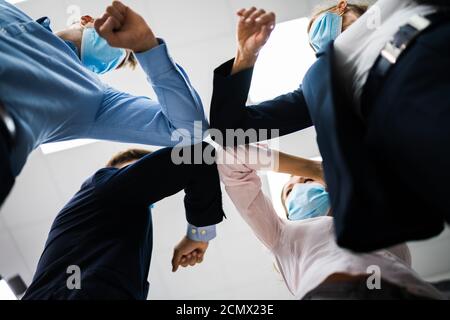 Employees Doing Elbow Bump To Avoid Flu And Stop Covid Spread Stock Photo