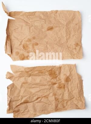 torn crumpled pieces of brown paper with grease stains Stock Photo