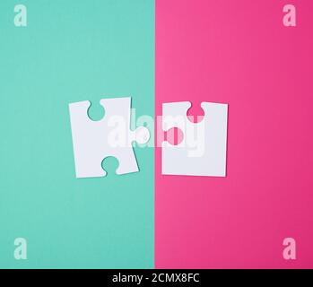 white large blank puzzles on a pink green background Stock Photo