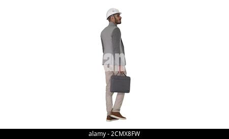 Engineer in helmet with briefcase walking on white background. Stock Photo