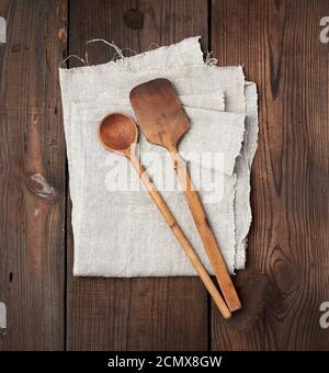 wooden old spoon and spatula on a gray linen napkin Stock Photo