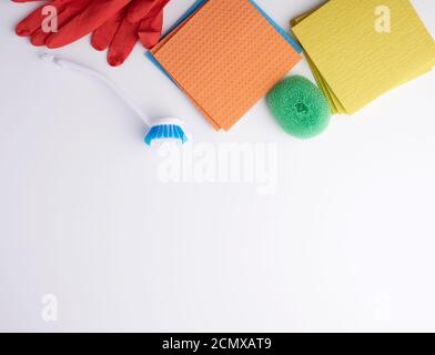 items for home cleaning: red rubber gloves, brush, multi-colored sponges for dusting Stock Photo