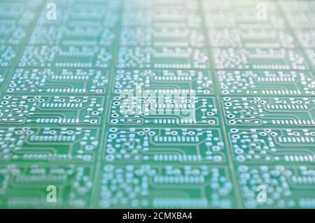 Multiplied green electronic circuit boards close-up with a shallow depth of field as a background. Concept for development of electronic circuits Stock Photo