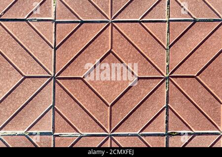 Yellow square-shaped pavement tiles.Beautiful quality texture closeup.Symmetrical pattern. Stock Photo