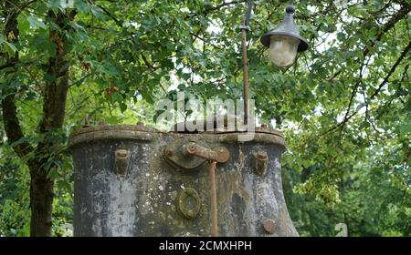 Metal well and a lamp in the middle of the forest Stock Photo