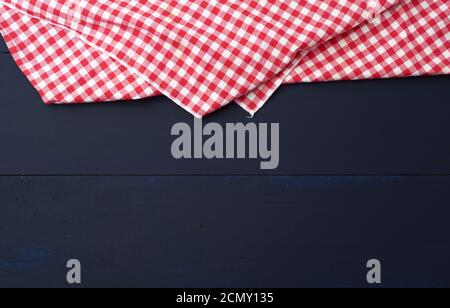 white red checkered kitchen towel on a blue wooden background Stock Photo