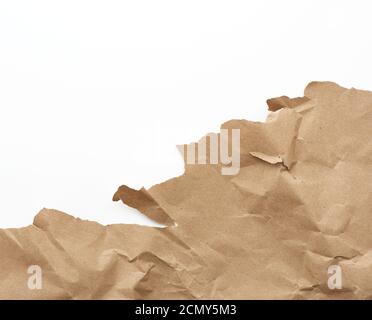 fragment of a crumpled blank sheet of brown wrapping kraft paper with torn edges Stock Photo