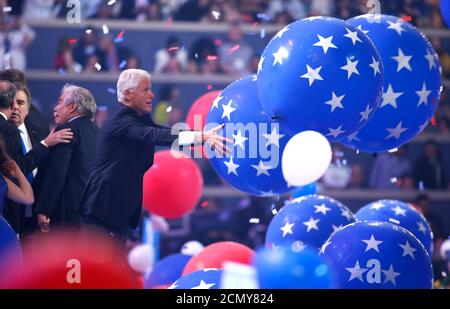 Former president Bill Clinton enjoys the balloon drop after his wife Democratic presidential nominee Hillary Clinton accepted the nomination on the fourth and final night at the Democratic National Convention in Philadelphia, Pennsylvania, U.S. July 28, 2016. REUTERS/Lucy Nicholson