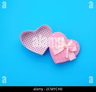 open empty cardboard box in the form of a heart on a light blue background Stock Photo