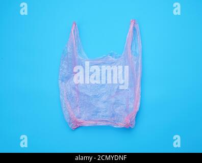 open empty plastic pink bag for products on a blue background Stock Photo
