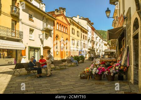 Croix de Ville street with people on benches and the monument to John Calvin in front of the evangelical Waldensian church in summer, Aosta, Italy Stock Photo