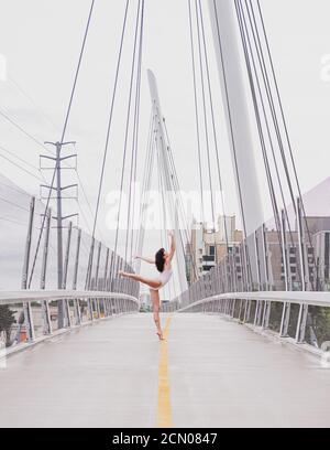 Ballerina on Suspension Bridge Stock Photo