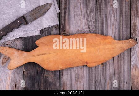 very old empty wooden cutting board and knife Stock Photo