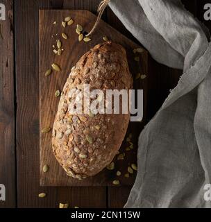 baked oval bread made from rye flour with pumpkin seeds Stock Photo