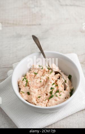 bowl of  pate  salmon with soft cheese and herb,  a textile napkin on a wooden table Stock Photo