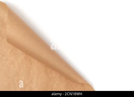 curved edge of a brown parchment paper sheet is isolated on a white background Stock Photo