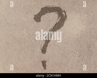 Question mark on a cement wall. Close-up. Background texture Stock Photo