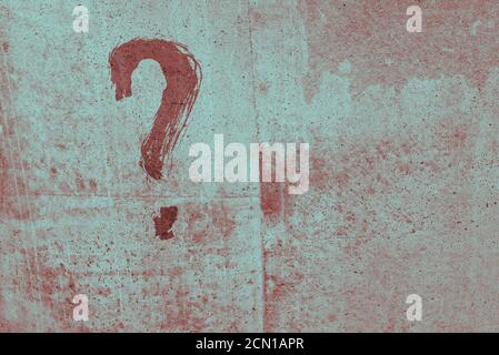 Question mark on an old wall. Red paint. Cement wall. Background surface Stock Photo