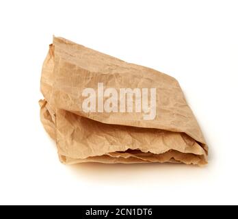 folded brown crumpled sheet of parchment paper isolated on white background Stock Photo