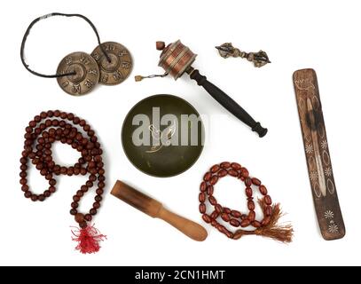 copper singing bowl, rosary, prayer drum, punitive, incense stand and wooden clapper Stock Photo