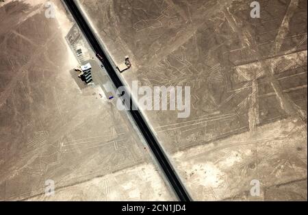 The Panamerican or Inter-American highway cuts through the Nazca Lines in the desert of southern Peru Stock Photo