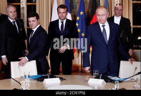 French President Emmanuel Macron, Russian President Vladimir Putin and Ukrainian President Volodymyr Zelenskiy arrive for a working session during a summit on the conflict in Ukraine at the Elysee Palace in Paris, France December 9, 2019. Ian Langsdon/Pool via REUTERS