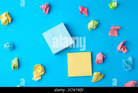 multicolored blank paper stickers of different colors on a blue background Stock Photo