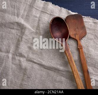 old empty brown wooden spoon on a gray surface Stock Photo