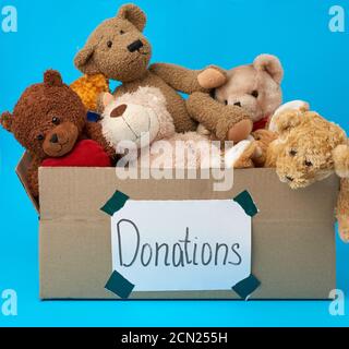 brown cardboard box filled with soft toys,inscription donations on the box Stock Photo