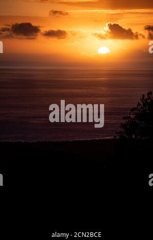 Sun going down over the ocean in Hawaii Stock Photo